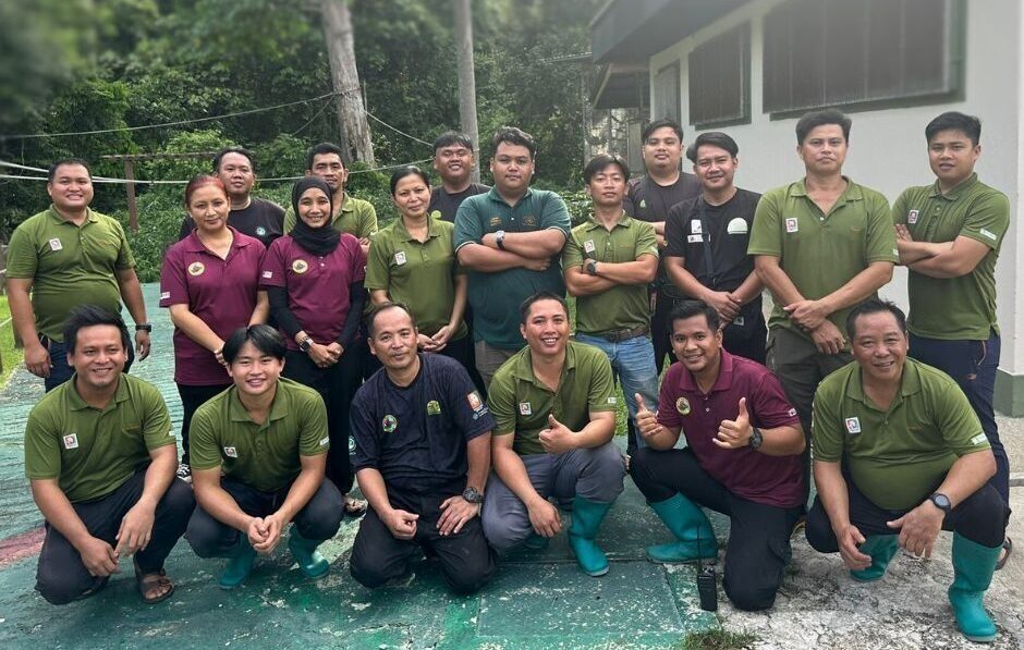 A group 19 members of staff sanding for a photo at Sepilok
