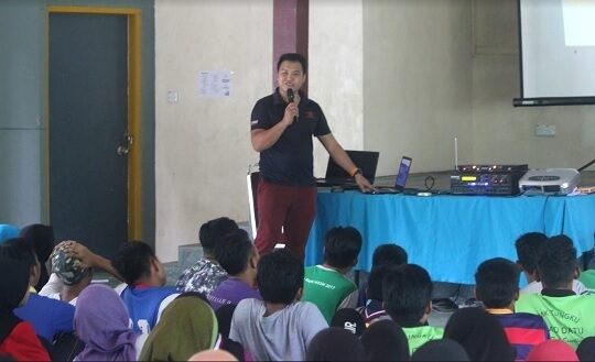 Orangutan Appeal UK team member presents education talk in front of students.