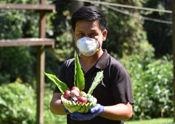 Team member holding Easter eggs for the orangutans