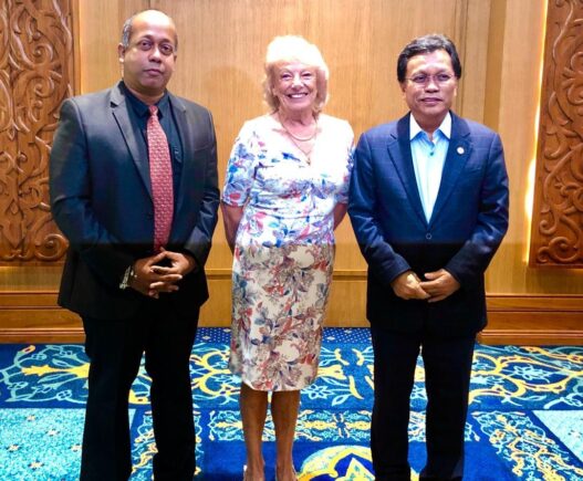 Three people standing side by side.