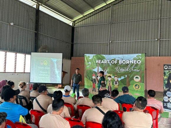 A team member from the HOB standing in front of a group giving a presentation.
