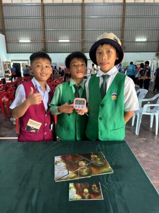 three children smiling after completing the orangutan puzzle
